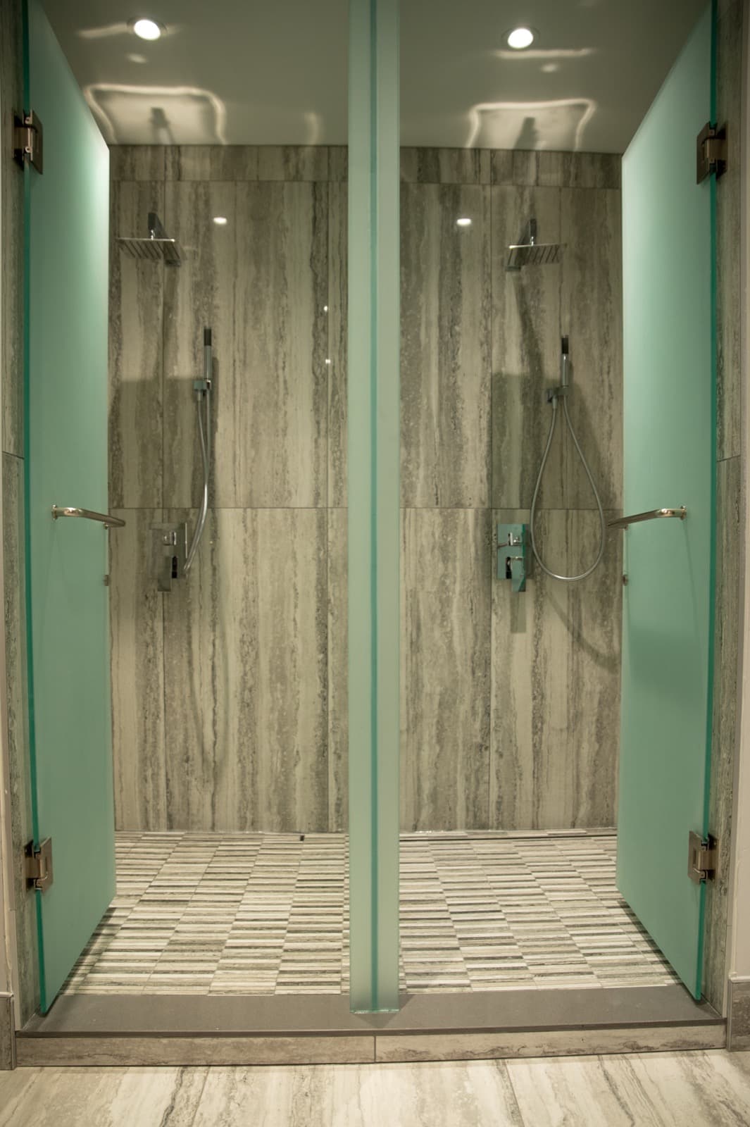 Stone-tiled private shower suites in the full-service change rooms at GoGo Muscle Training