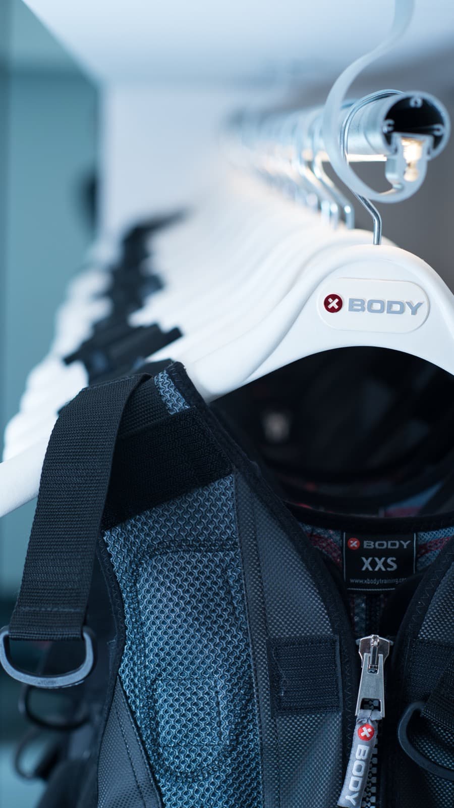 Close-up of a fitted XBody EMS training suit hanging at the GoGo Muscle Training studio