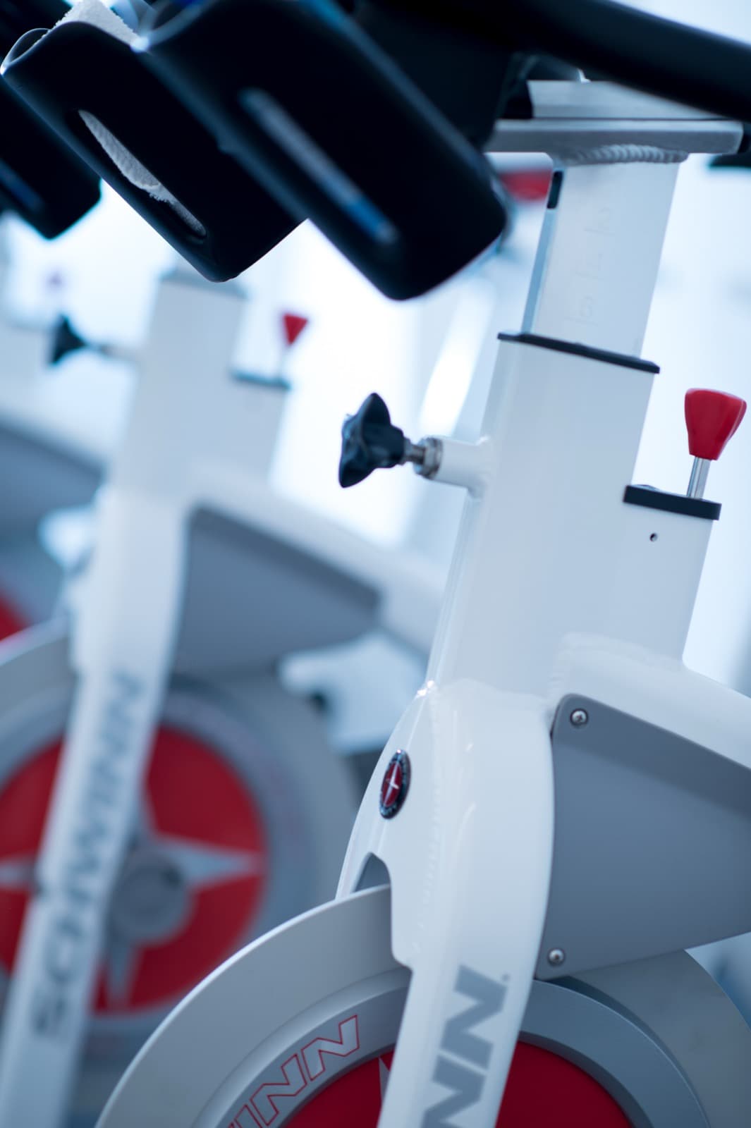 Detail of the red-accented spin bikes in the GoGo cardio studio