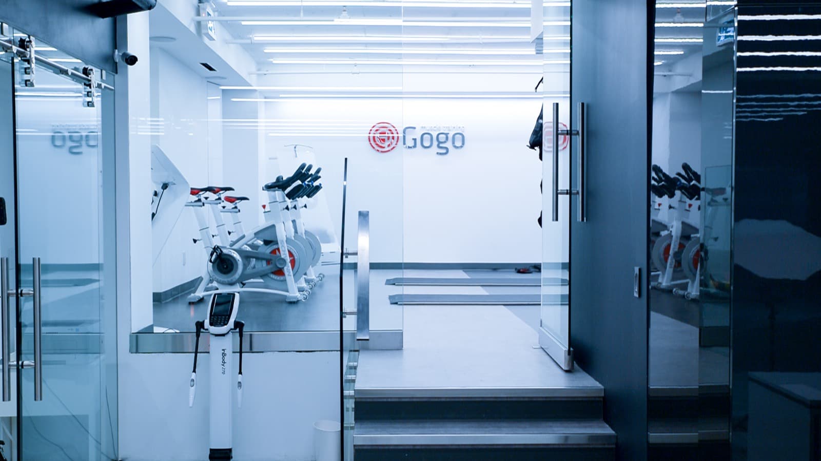 Wide cinematic view of the GoGo Muscle Training studio interior